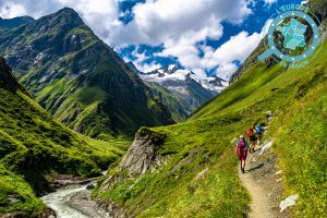 Hiking Group In Valley Of Umbalfaelle On Grossvenediger With View To Mountain Roetspitze In Nationalpark Hohe Tauern In Tirol In Austria